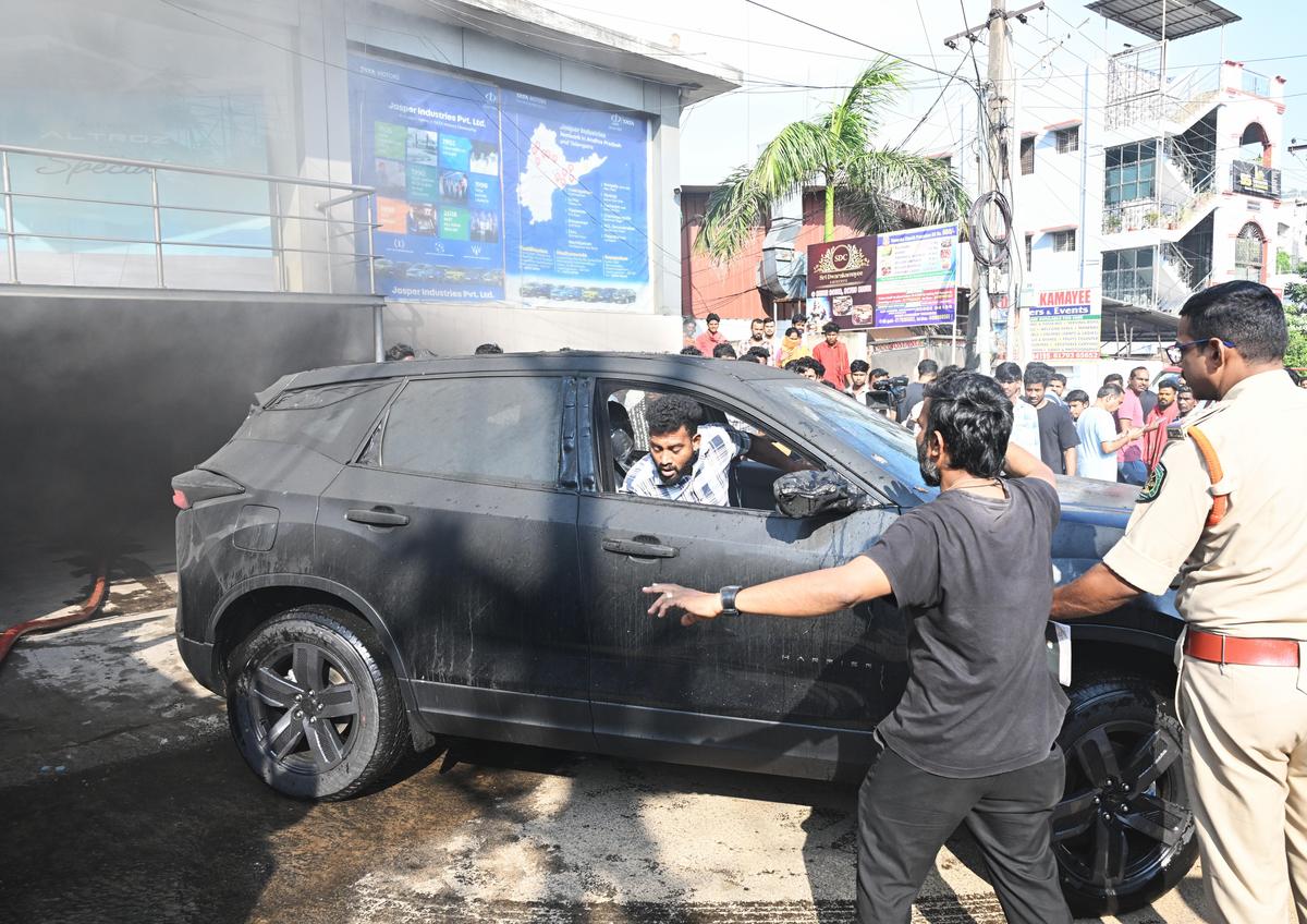 A partially burnt car being removed from inside a building that caught fire in Maddilapalem Visakhapatnam on Thursday.. 