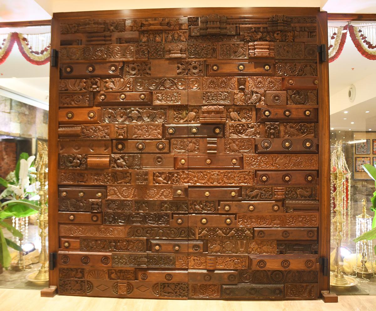 A gigantic door made with pieces of discarded doors, at Illam Hospitality and Banquets in Sholinganallur, Chennai. 