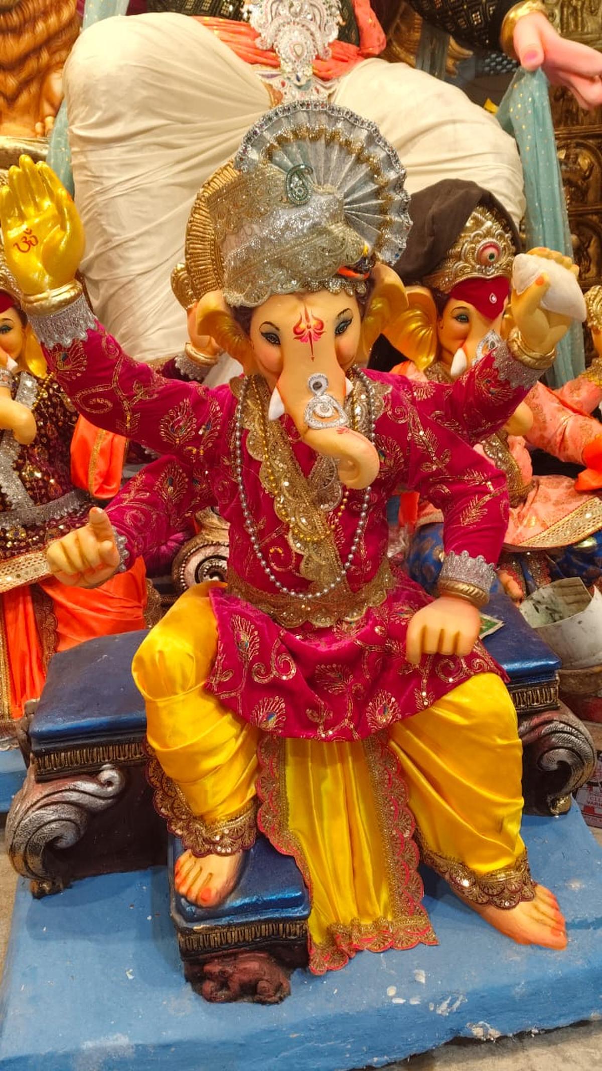 Ganesha wearing a kurta, dhoti and pagidi on top 