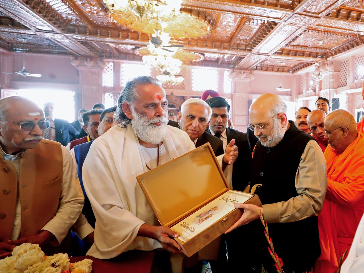 Seers present a copy of the Bhagavad Gita to Home Minister Amit Shah at the ‘International Gita Mahotsav, in Kurukshetra on December 22, 2023.