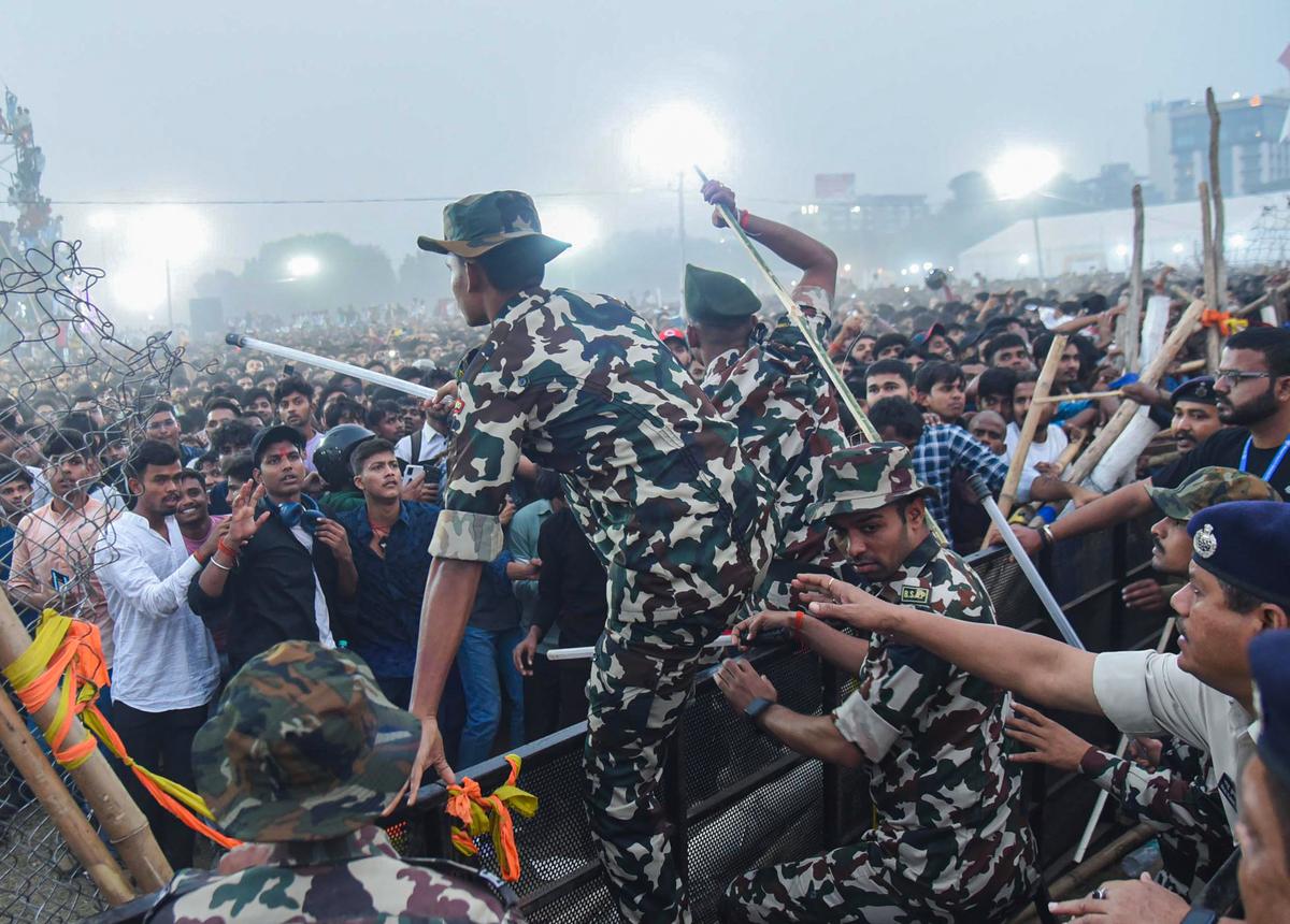 Security personnel try to disperse fans as they arrive to see actors Allu Arjun and Rashmika Mandanna during the trailer launch of the film ‘Pushpa 2: The Rule’, at Gandhi Maidan, in Patna on Sunday. (November 17, 2024).