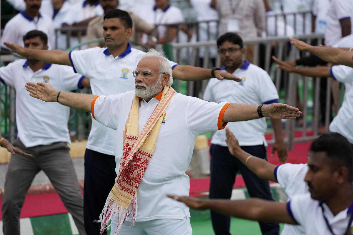 Indian Prime Minister Narendra Modi performs yoga along with thousands of Indians to mark International Day of Yoga at Mysore Palace, in Mysuru, India, on Tuesday, June 21, 2022. 