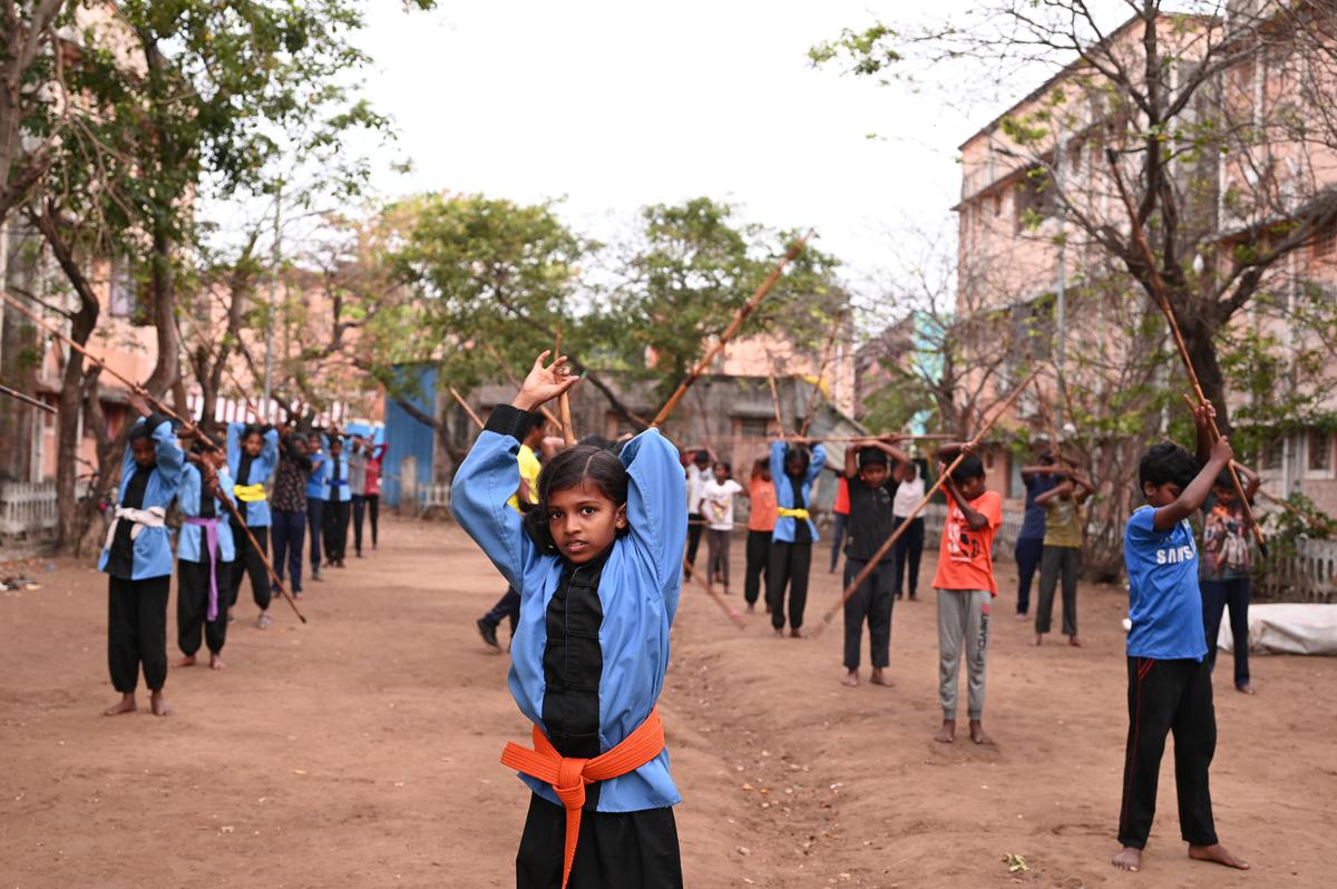 The children of Kannagi Nagar practising Silambam wearing Kung Fu uniforms