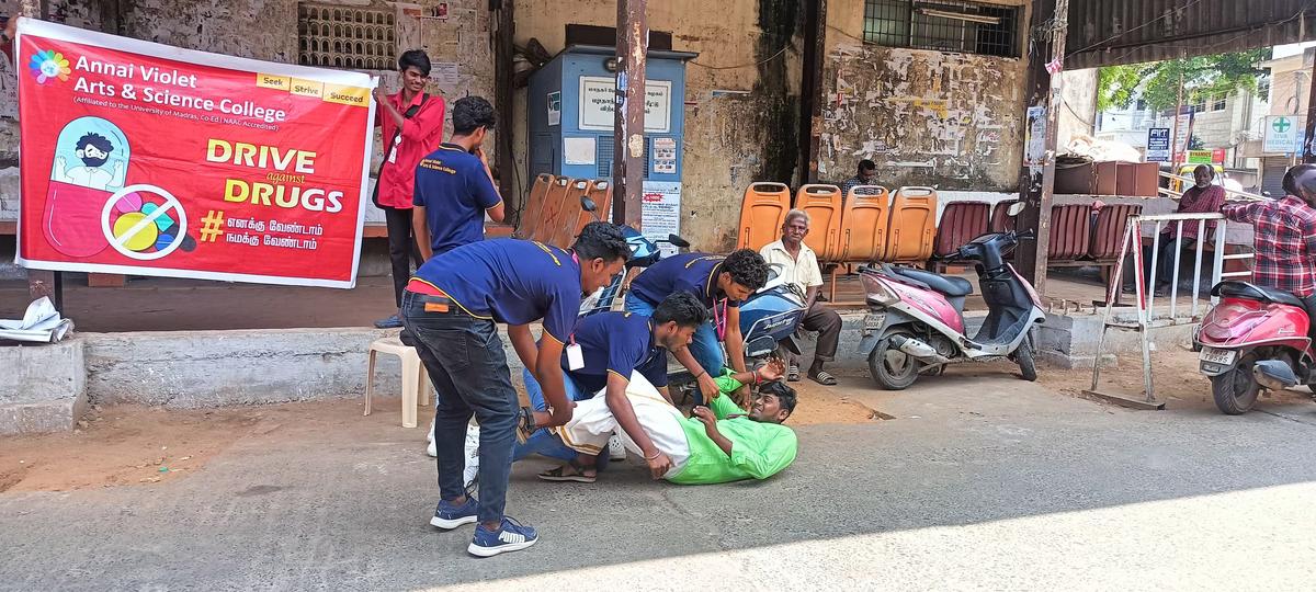 Students perform a skit near a busy section of the road to promote the idea of a drug-free society. Students perform a skit near a busy section of the road to promote the idea of a drug-free society.