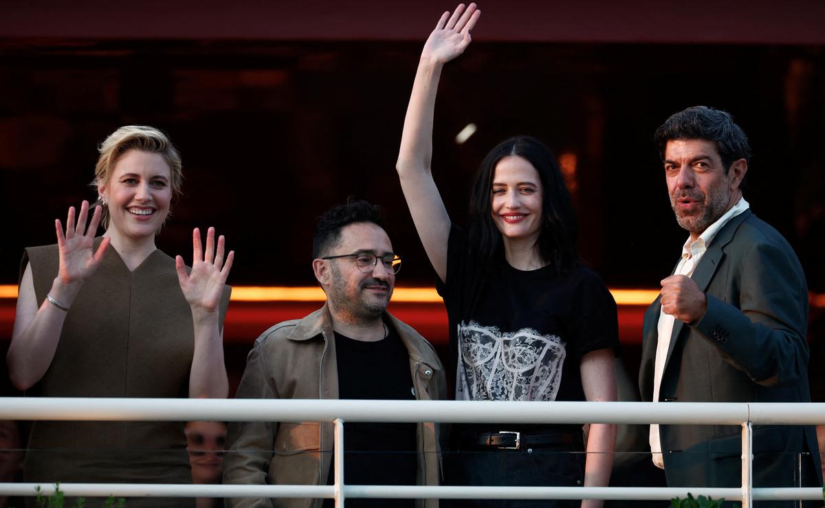 Jury President of the 77th Cannes Film Festival Greta Gerwig and jury members Juan Antonio Bayona, Eva Green and Pierfrancesco Favino stand on a balcony at the Hotel Martinez on the eve of the opening of the 77th Cannes Film Festival in Cannes, France