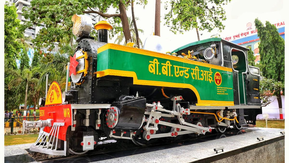 A heritage steam locomotive and lawn outside Mumbai Central station