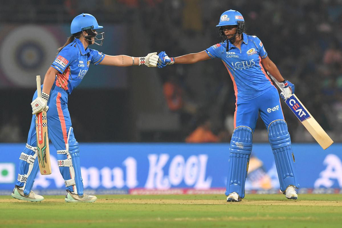 Mumbai Indians’ Amelia Kerr, left, and captain Harmanpreet Kaur bump fists during the Women’s Premier League match against Gujarat Giants at the DY Patil Stadium in Navi Mumbai on March 4, 2023.