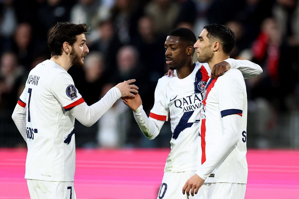 Paris St Germain’s Ousmane Dembele, centre, celebrates a goal with Khvicha Kvaratskhelia and Achraf Hakimi 