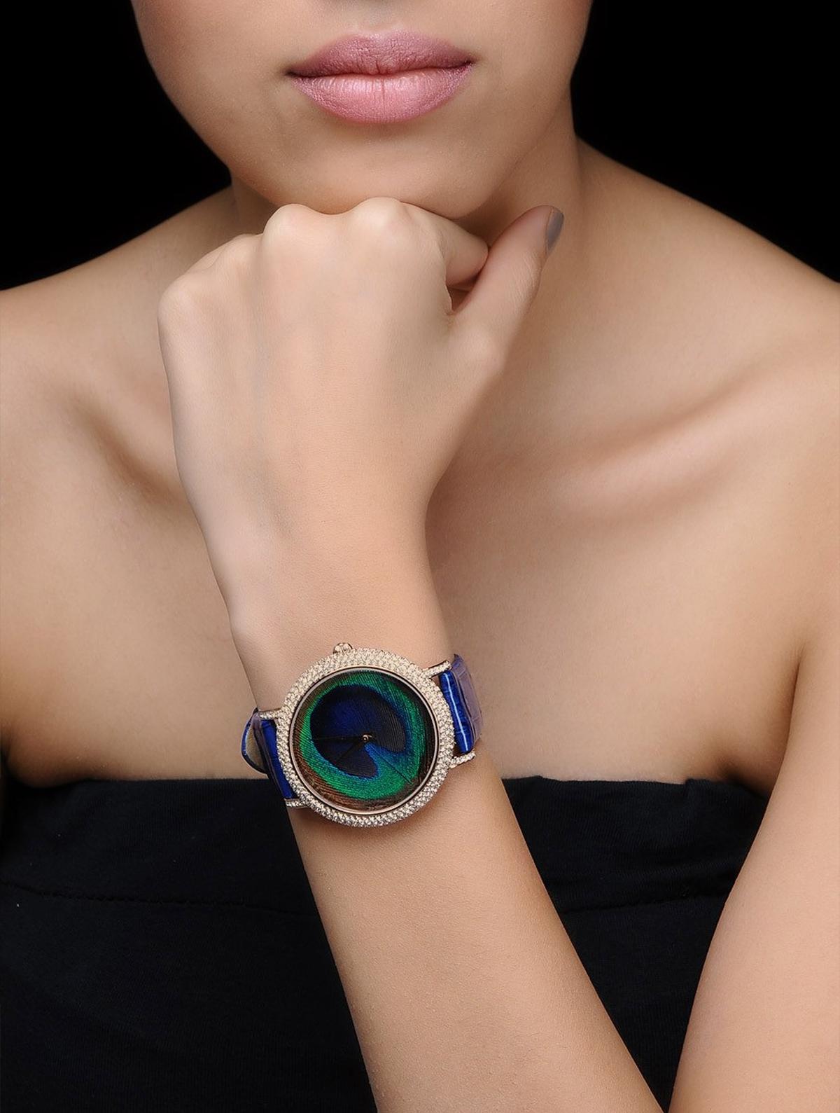 A peacock-themed watch that uses a real, fallen peacock feather in the dial.