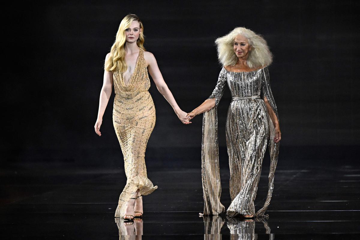 Elle Fanning (L) and Helen Mirren (R) present creations for L’Oreal Paris during a show as part of the Paris Fashion Week Womenswear Spring/Summer 2024 in Paris 