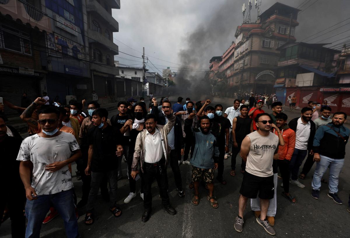 Demonstrators shout slogans as they gather to protest against Monday’s killing of 19 people after anti-corruption protests that were triggered by a social media ban which was later lifted, during a curfew in Kathmandu.  