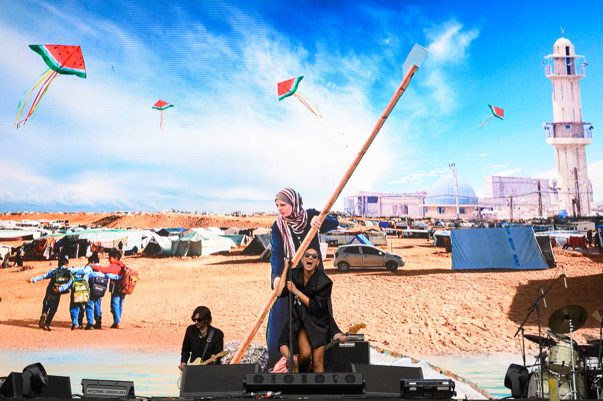 Nadine Shah performs in front of a large image of Gaza, on the Other Stage during day five of Glastonbury festival 2025 at Worthy Farm, Pilton on June 29, 2025 in Glastonbury, England. 