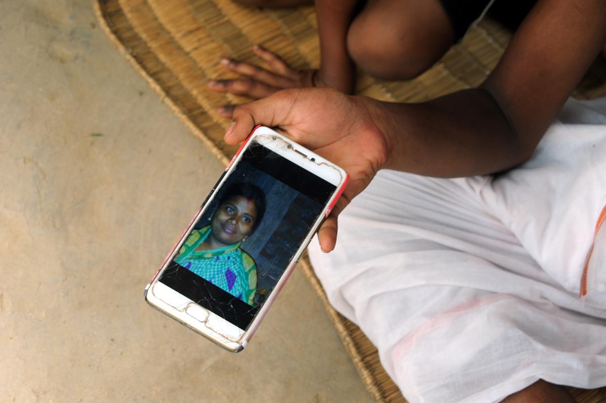 A child shows his mother's picture on a smartphone during a blast at an illegal firecracker manufacturing unit in Khadirul village in West Bengal's Purba Medinipur district. 