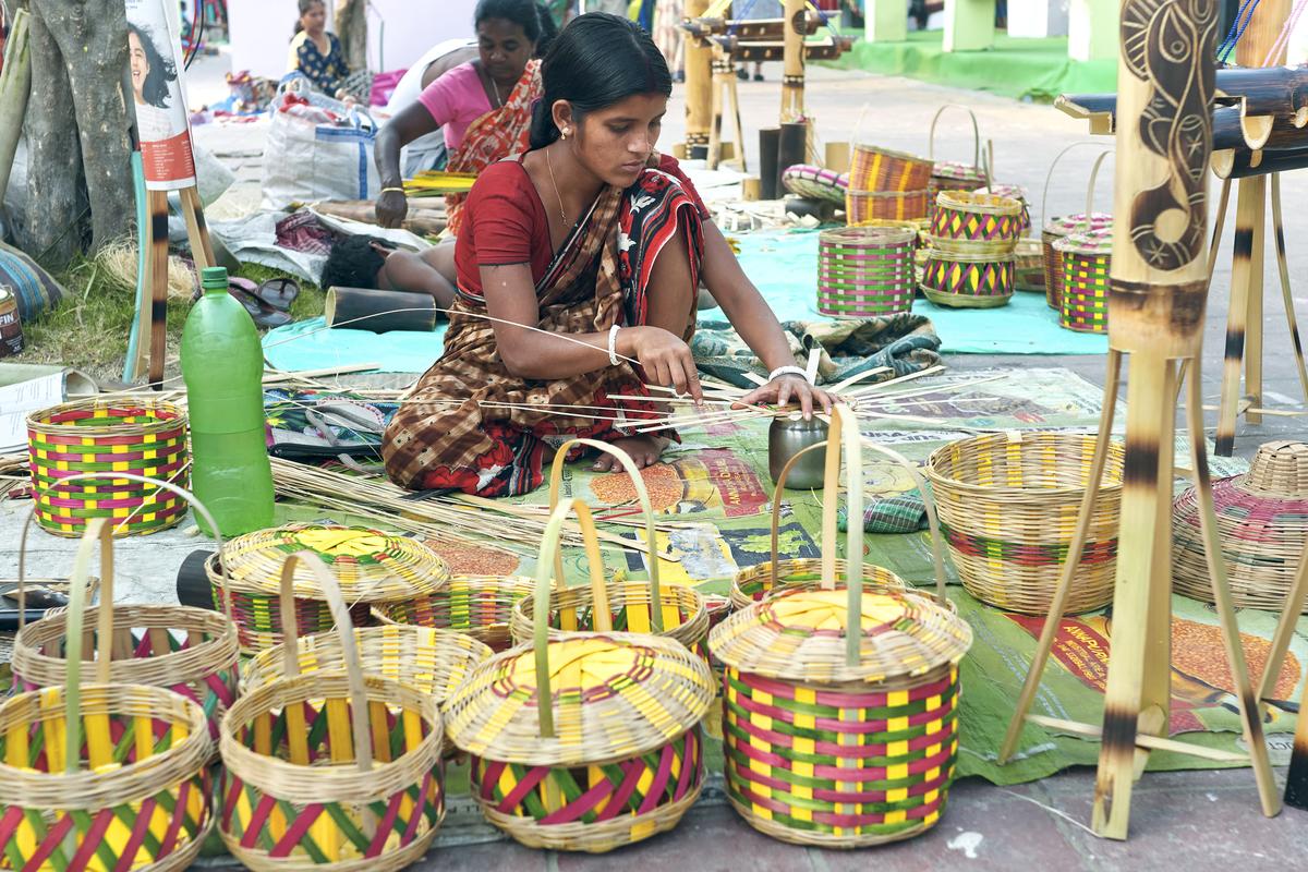 An artisan from a rural community making bamboo baskets.