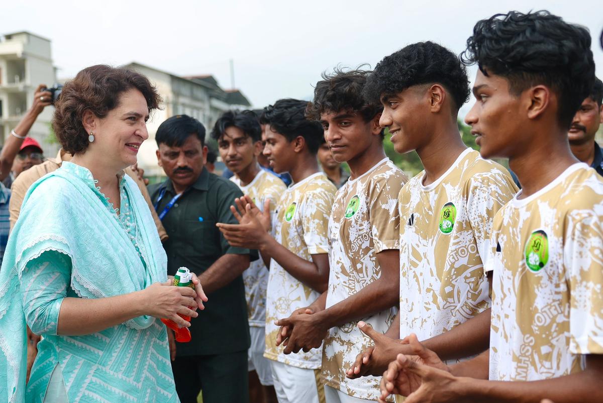 Priyanka Gandhi speaking to young footballers at Seeti Haji Stadium at Edavanna during her campaign in Wayanad Lok Sabha constituency on Tuesday.