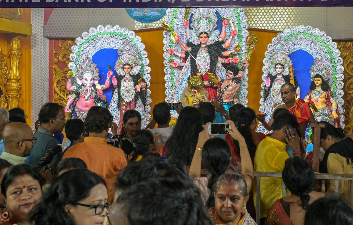 Visitors offering prayers as the 64th Sarbojanin and ECo Railway Durga Puja begin at Waltair Kalibari in Visakhapatnam .