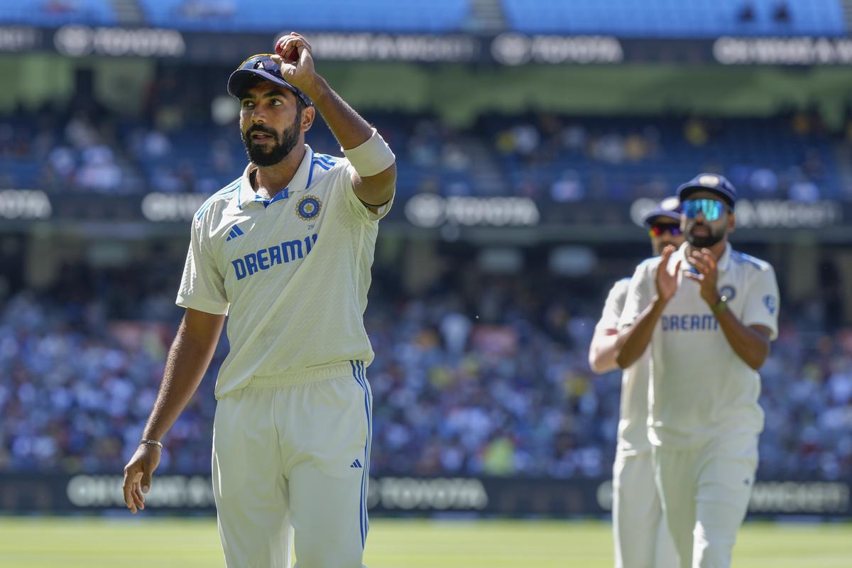 India’s Jasprit Bumrah holds up the ball as he leaves the field after taking the five wickets during play on the last day of the fourth cricket test between Australia and India at the Melbourne Cricket Ground, Melbourne, Australia, Monday, Dec. 30, 2024