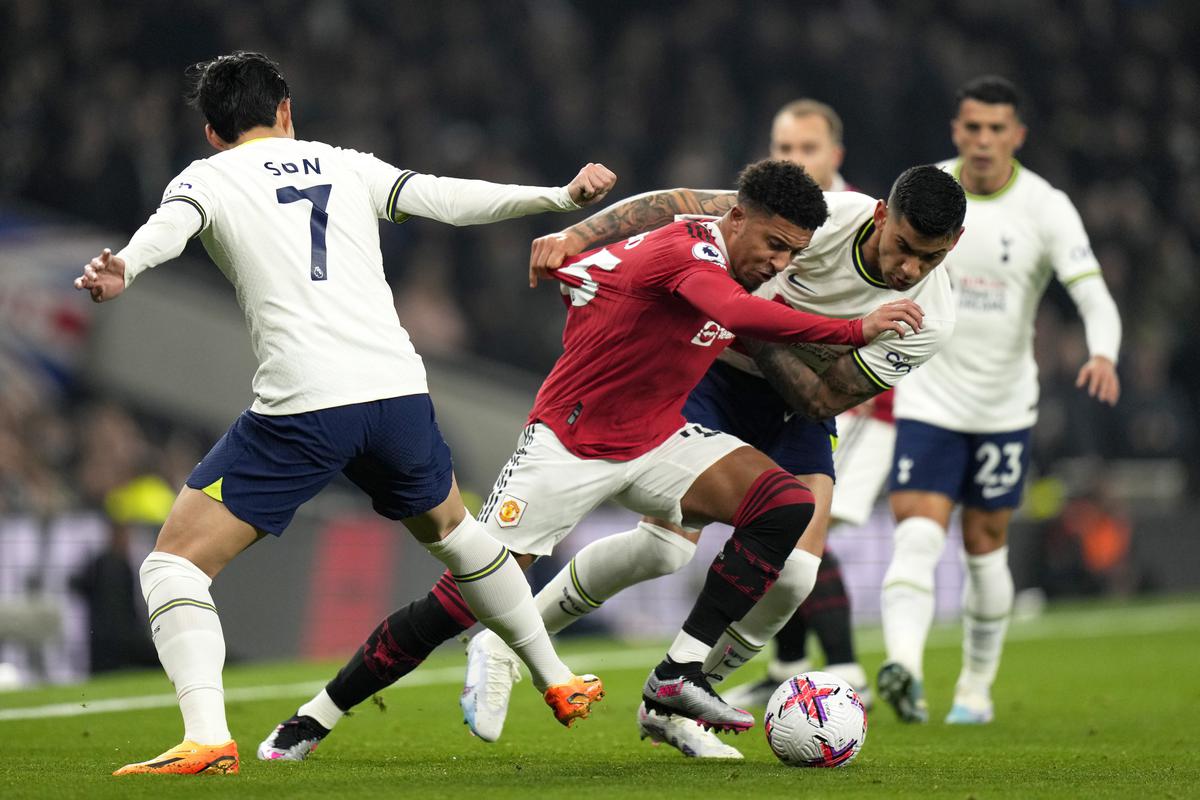 Manchester United’s Jadon Sancho fights for the ball with Tottenham’s Son Heung-min and Cristian Romero during the English Premier League match at White Hart Lane, in London, on April 27, 2023. 