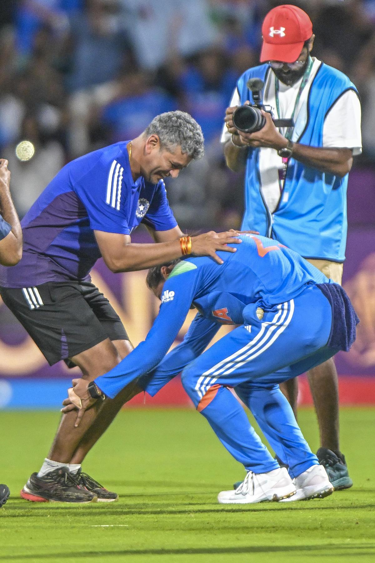 India’s captain Harmanpreet Kaur touches feet of coach Amol Muzumdar  as they celebrate after winning the match during the ICC Women’s World Cup Final match India vs South Africa at the DY Patil Stadium in Navi Mumbai on Sunday.  