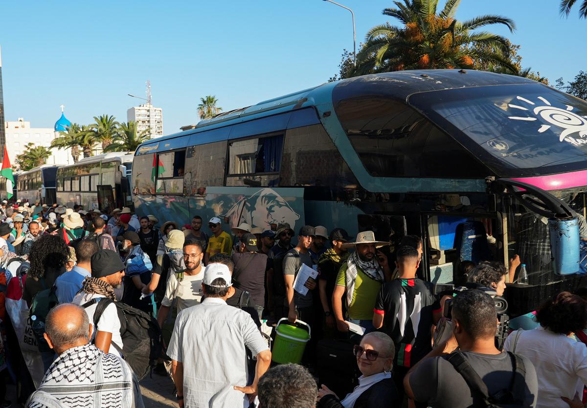Participants of a Tunisian-led land convoy, who aim to reach Gaza and call for an end to the conflict in the region, wait to board buses, in Tunis, Tunisia June 9, 2025. 