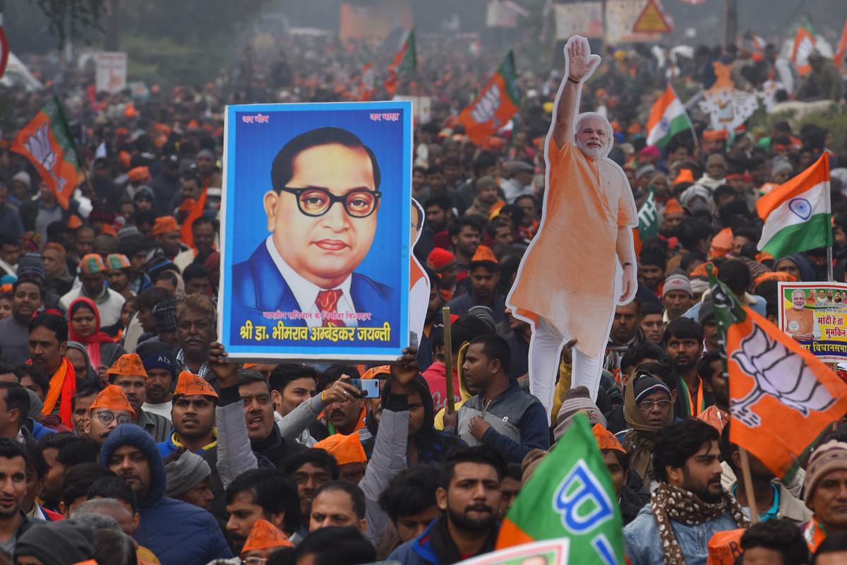 A BJP supporter holds up an image of Ambedkar during Prime Minister Narendra Modi’s rally at Ramlila Maidan in New Delhi.