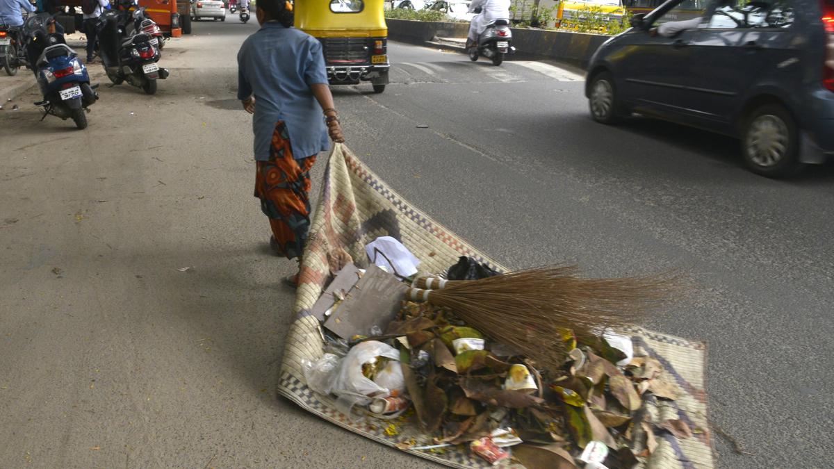 Dragging waste on mats and cardboards, pourakarmikas toil without basic resources