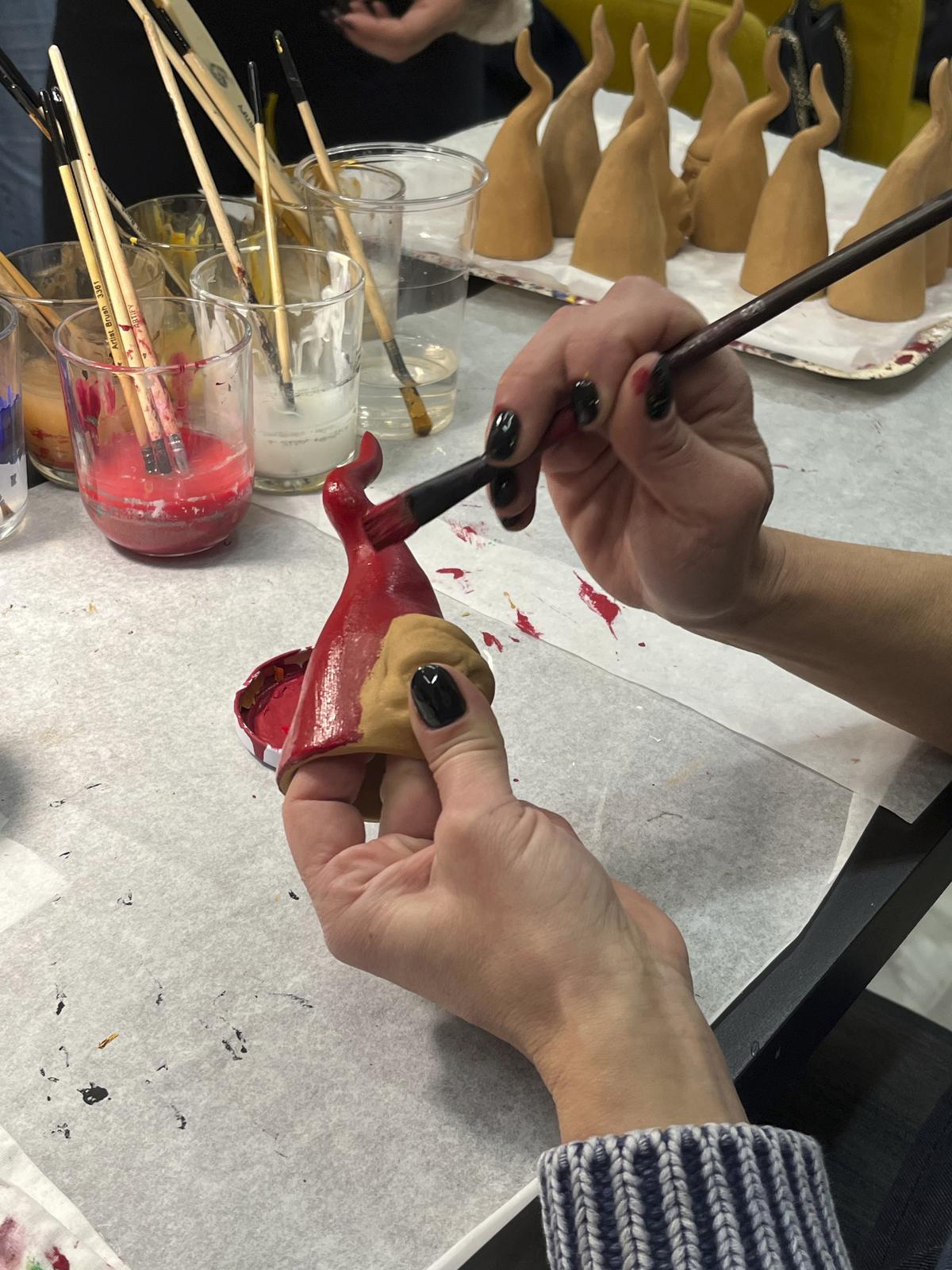 Mariana Mattei puts a final touch on Neapolitan horns in a shop in Naples, southern Italy.