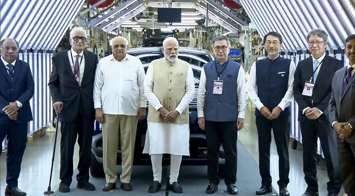 In this screengrab from a video released on Aug. 26, 2025, Prime Minister Narendra Modi with Gujarat Chief Minister Bhupendra Patel and others, during a flagging off ceremony of Maruti Suzuki’s first electric vehicle e-Vitara from Hansalpur manufacturing facility, Gujarat. Source: YouTube/Narendra Modi