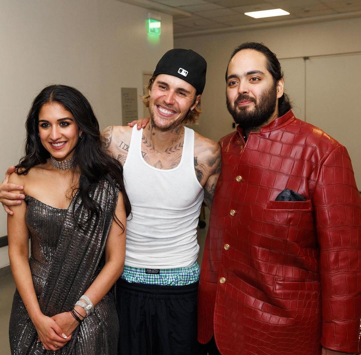 Singer Justin Bieber poses for a photo with Anant Ambani and his fiancé Radhika Merchant during pre-wedding festivities of the couple, in Mumbai.