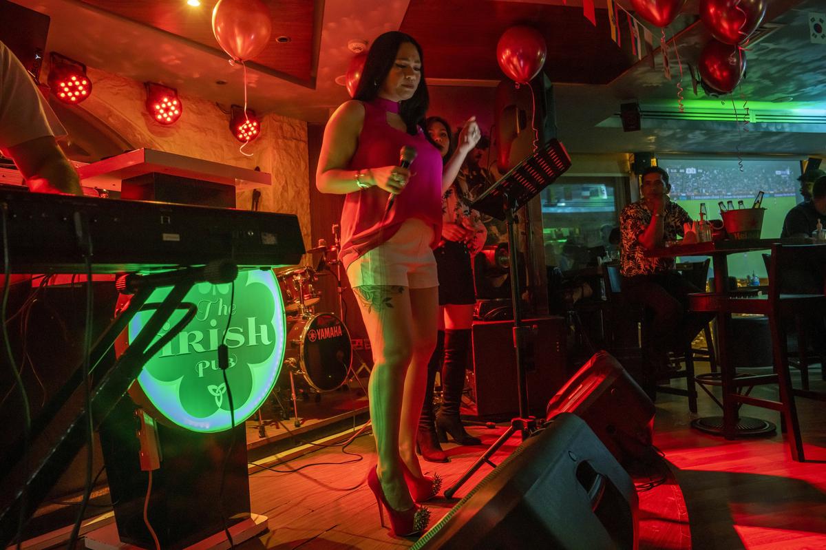 A woman sings at “The Irish Pub,” which will be one of the bars showing World Cup 2022 matches on live screens, in Doha, Qatar. A recent outpouring of local anger to scenes of foreign artists and models reveling in Qatar underscored the tensions tearing at the conservative Muslim emirate.