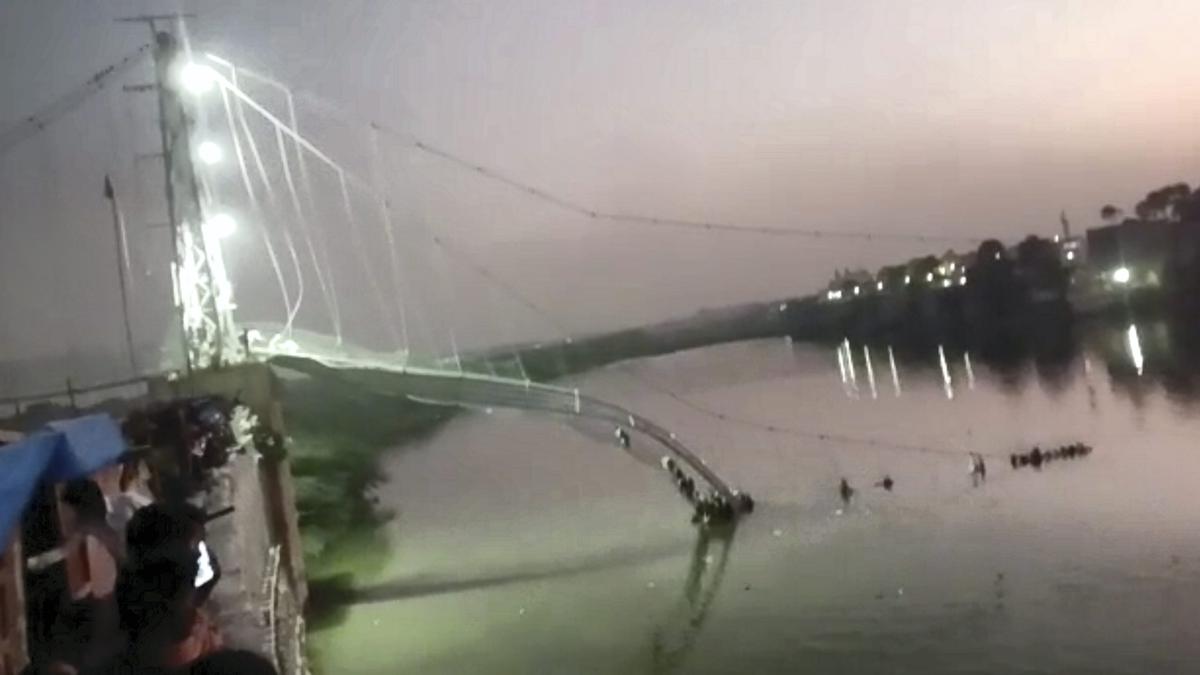 Scores of people fall into river after suspension bridge collapses in Gujarat’s Morbi