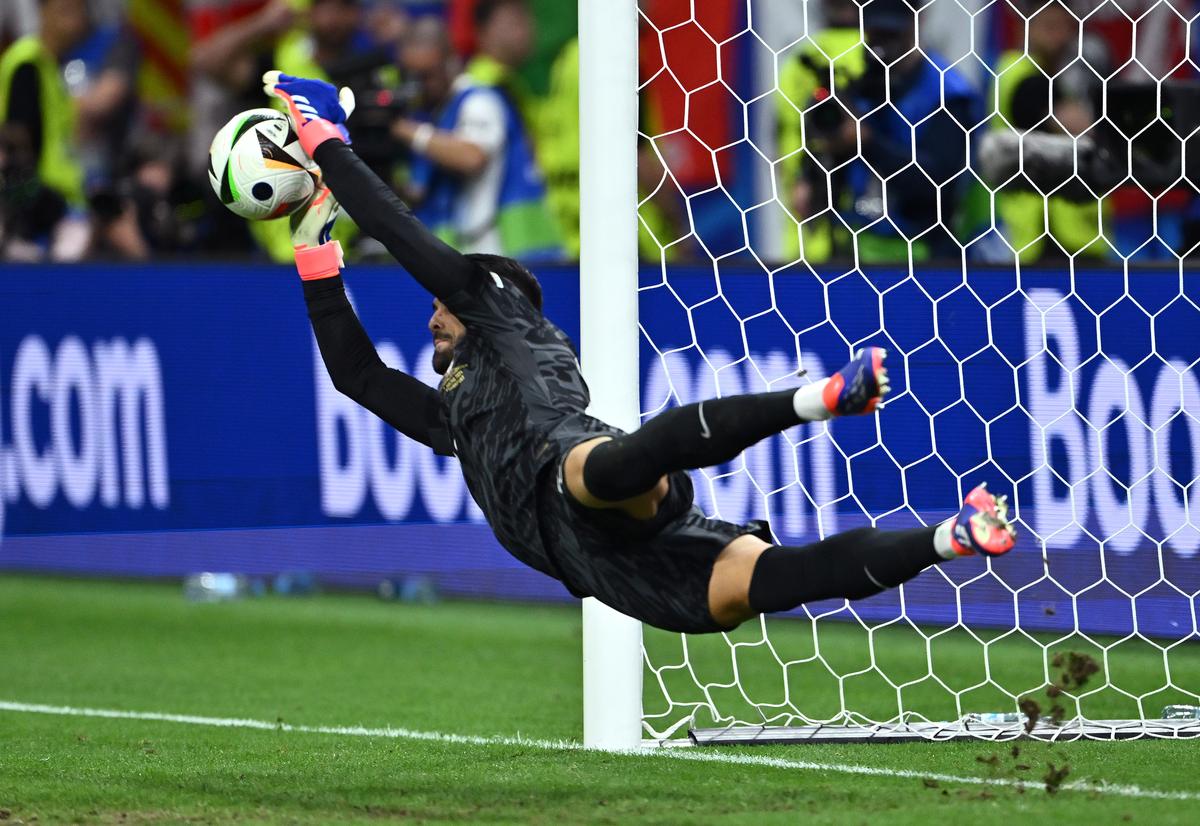 Portugal’s Diogo Costa saves the third penalty in the penalty shootout during the UEFA EURO 2024 round of 16 match against Slovenia at Frankfurt Arena in Frankfurt am Main, Germany on July 1, 2024.
