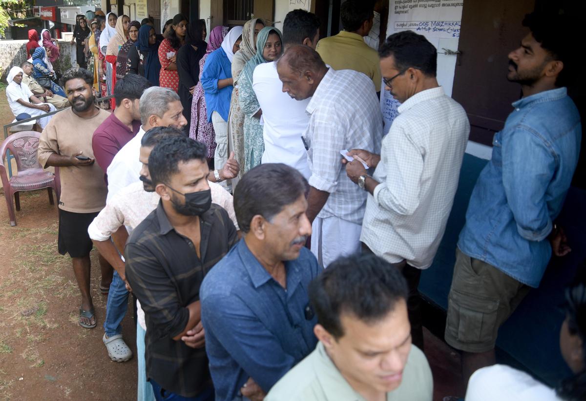 People wait to cast their votes at AMLP School in Moozhikkal, Kozhikode, on Thursday. 