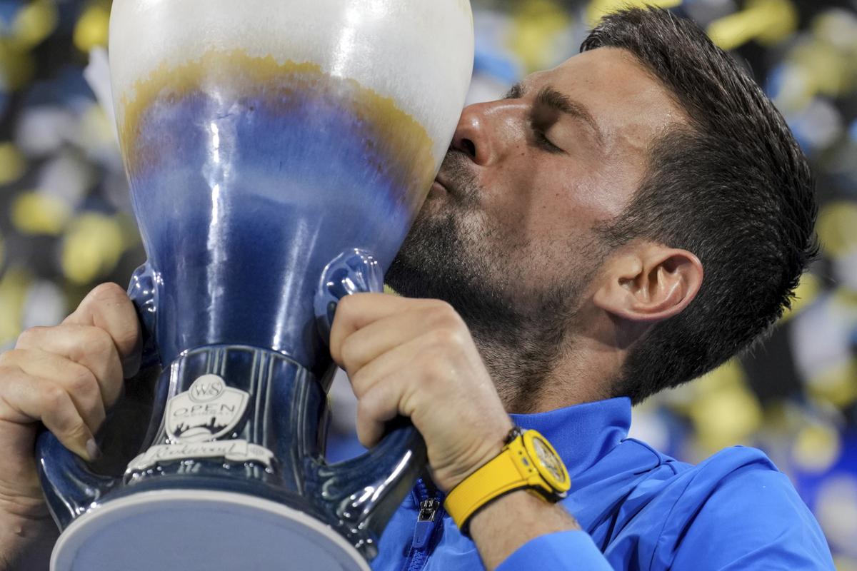 Novak Djokovic, of Serbia, kisses the Rookwood Cup as he poses for photos after defeating Carlos Alcaraz, of Spain, during the men’s singles final of the Western & Southern Open tennis tournament.