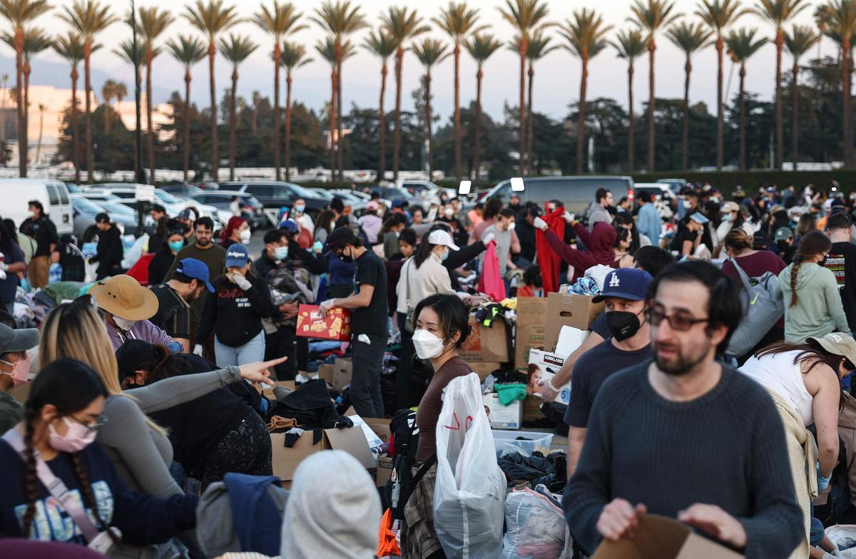 People gather and sort through donated clothing and other items at a pop-up donation center for wildfire victims at Santa Anita race track on January 11, 2025 in Santa Anita, California. 