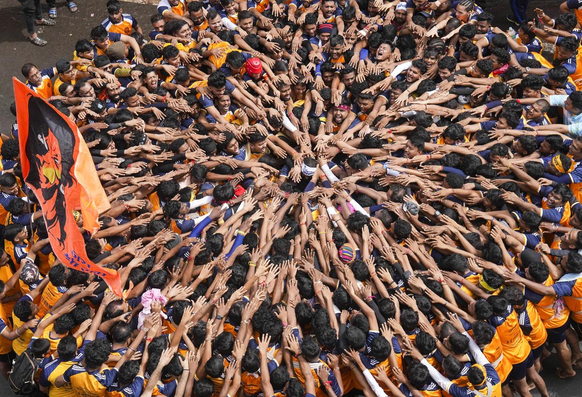 Devotees pray before they form a human pyramid to break the ‘dahi handi’, an earthen pot filled with curd, as part of ‘Janmashtami’ festival celebrations, at Dadar in Mumbai, Tuesday, Aug. 27, 2024. Devotees pray before they form a human pyramid to break the ‘dahi handi’, an earthen pot filled with curd, as part of ‘Janmashtami’ festival celebrations, at Dadar in Mumbai, Tuesday, Aug. 27, 2024.