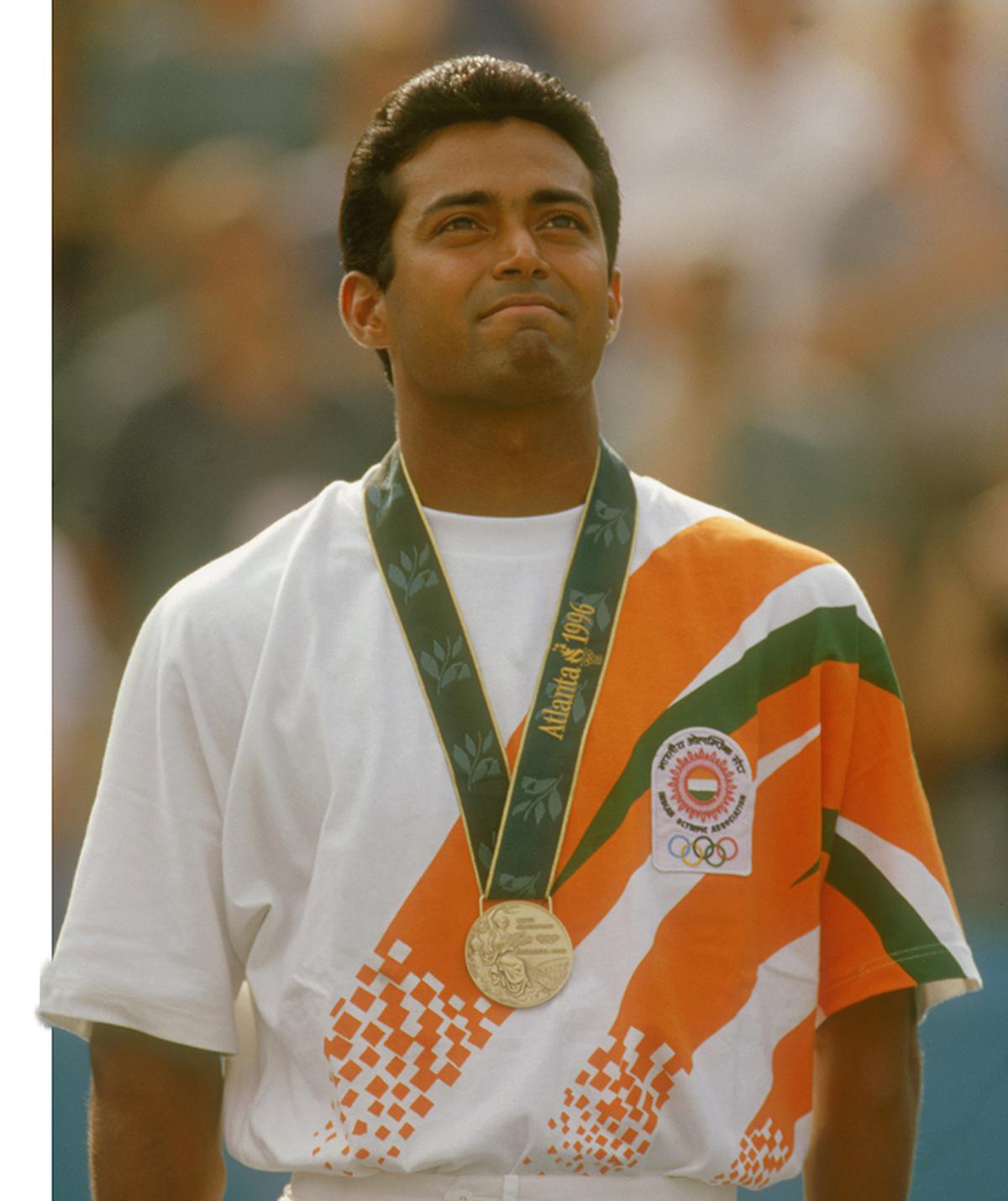 Leander Paes stands on the podium after winning a bronze medal in the men’s singles tennis event at the 1996 Summer Olympic Games in Atlanta.