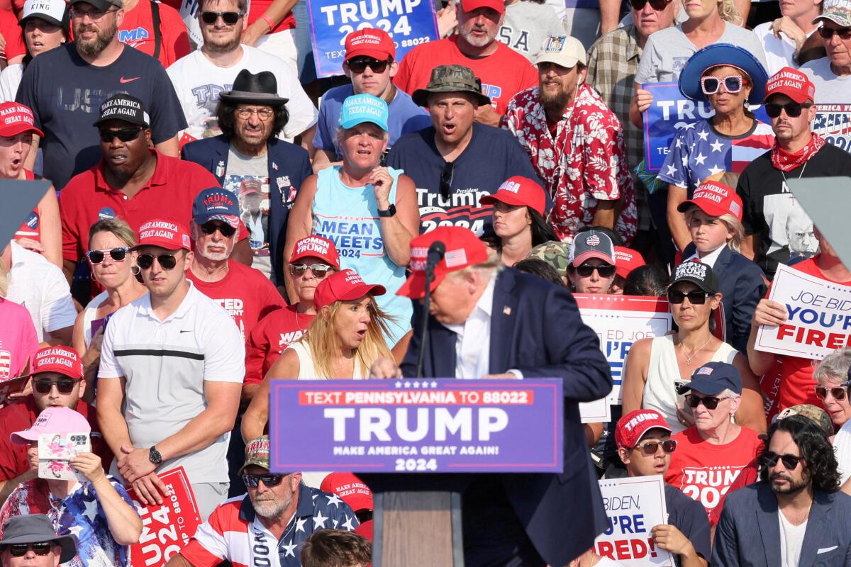 Donald Trump reacts after gunfire rang out during a campaign rally at the Butler Farm Show in Butler, Pennsylvania, U.S., July 13, 2024.