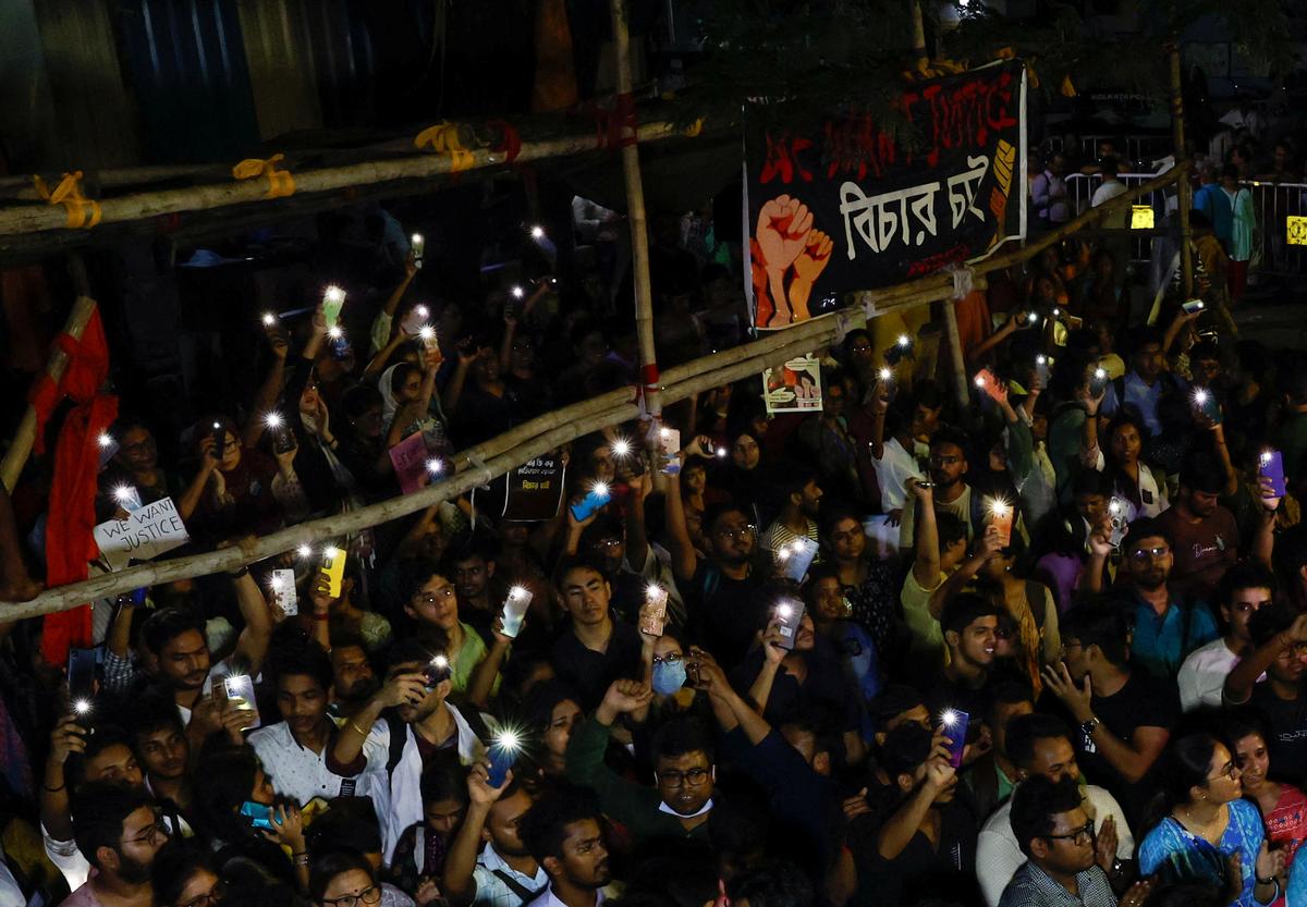 Doctors, paramedics and medical students hold their phone flashlights during a protest against what they say is rape and murder of a trainee doctor, inside the premises of RG Kar Medical College and Hospital in Kolkata.