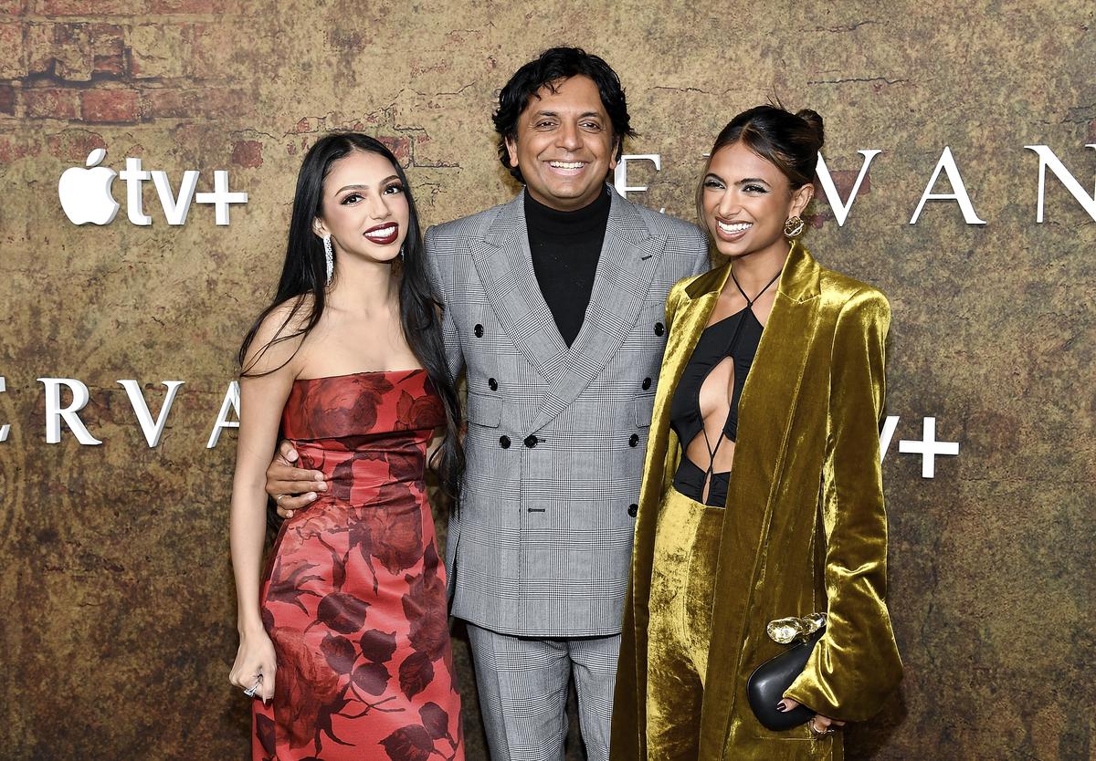 M. Night Shyamalan, center, and daughters Saleeka Shyamalan, left, and Ishani Shyamalan attend the 'Servant' Season 4 premiere on Apple+ TV 