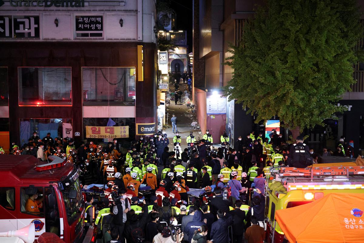 Rescue team and firefighters work at the scene where dozens of people were injured in a stampede during a Halloween festival in Seoul, South Korea, on October 29, 2022.