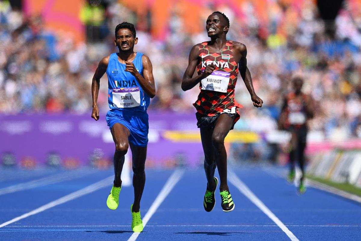 India’s Avinash Sable runs Kenya’s Abraham Kibiwot close during the men’s 3000m steeplechase final athletics event at the Alexander Stadium, in Birmingham on day nine of the Commonwealth Games in Birmingham, on August 6, 2022. 