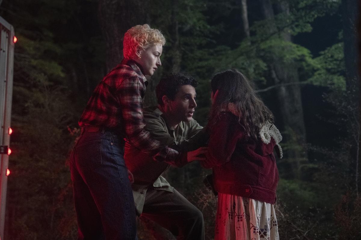 Julia Garner, from left, Christopher Abbott, and Matilda Firth in a scene from ‘Wolf Man’