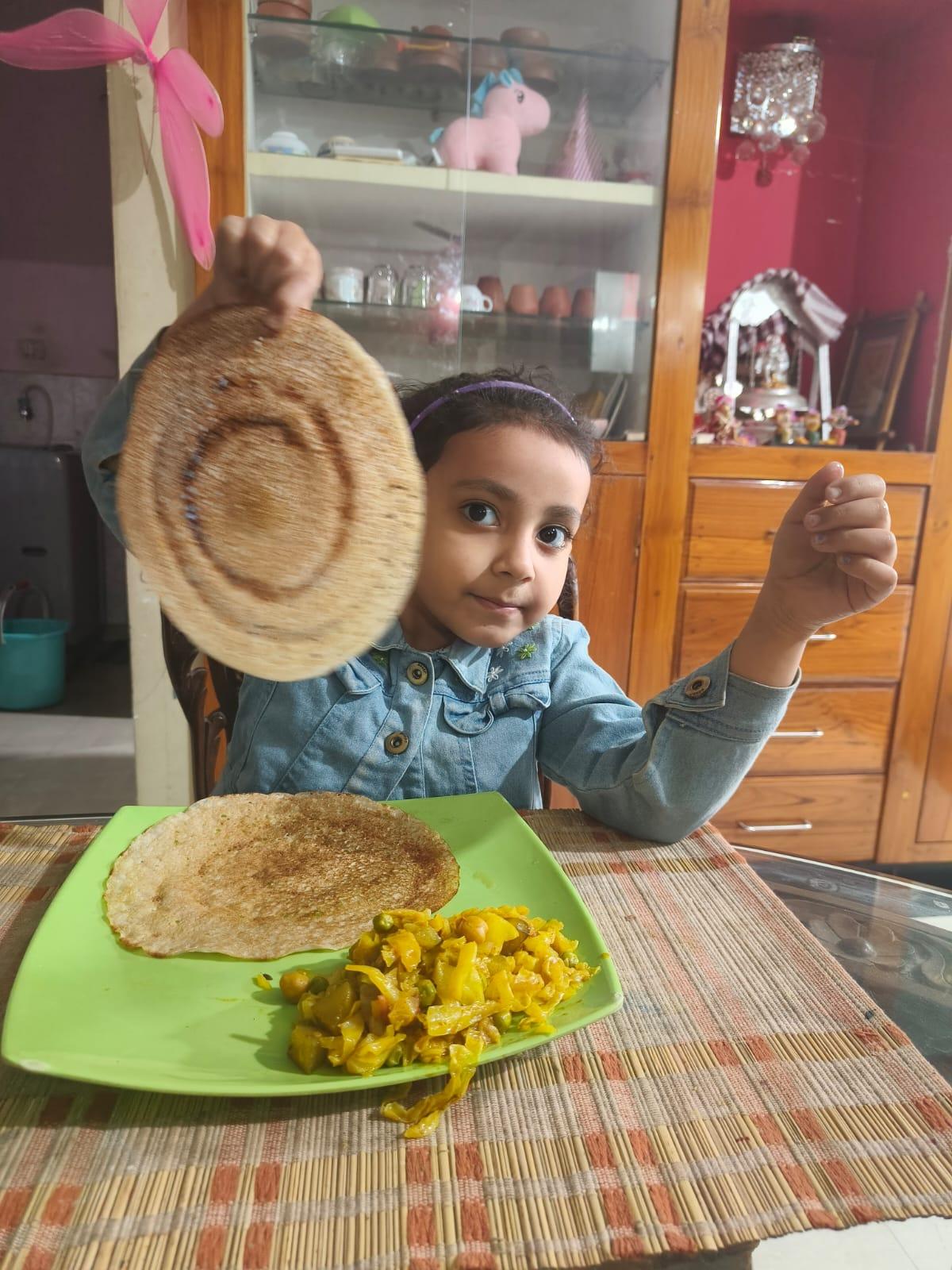 A kid posing with tender jackfruit dosaย A kid posing with tender jackfruit dosaย