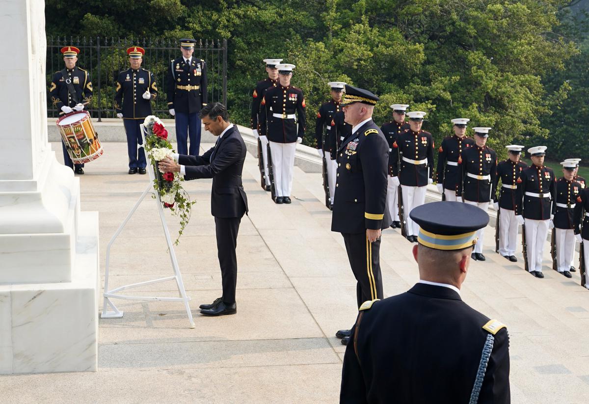 British Prime Minister Rishi Sunak, center left, pays his respects at a wreath at the Tomb of the Unknown Soldier in Arlington National Cemetery during his visit to Washington D.C., on June 7, 2023. 