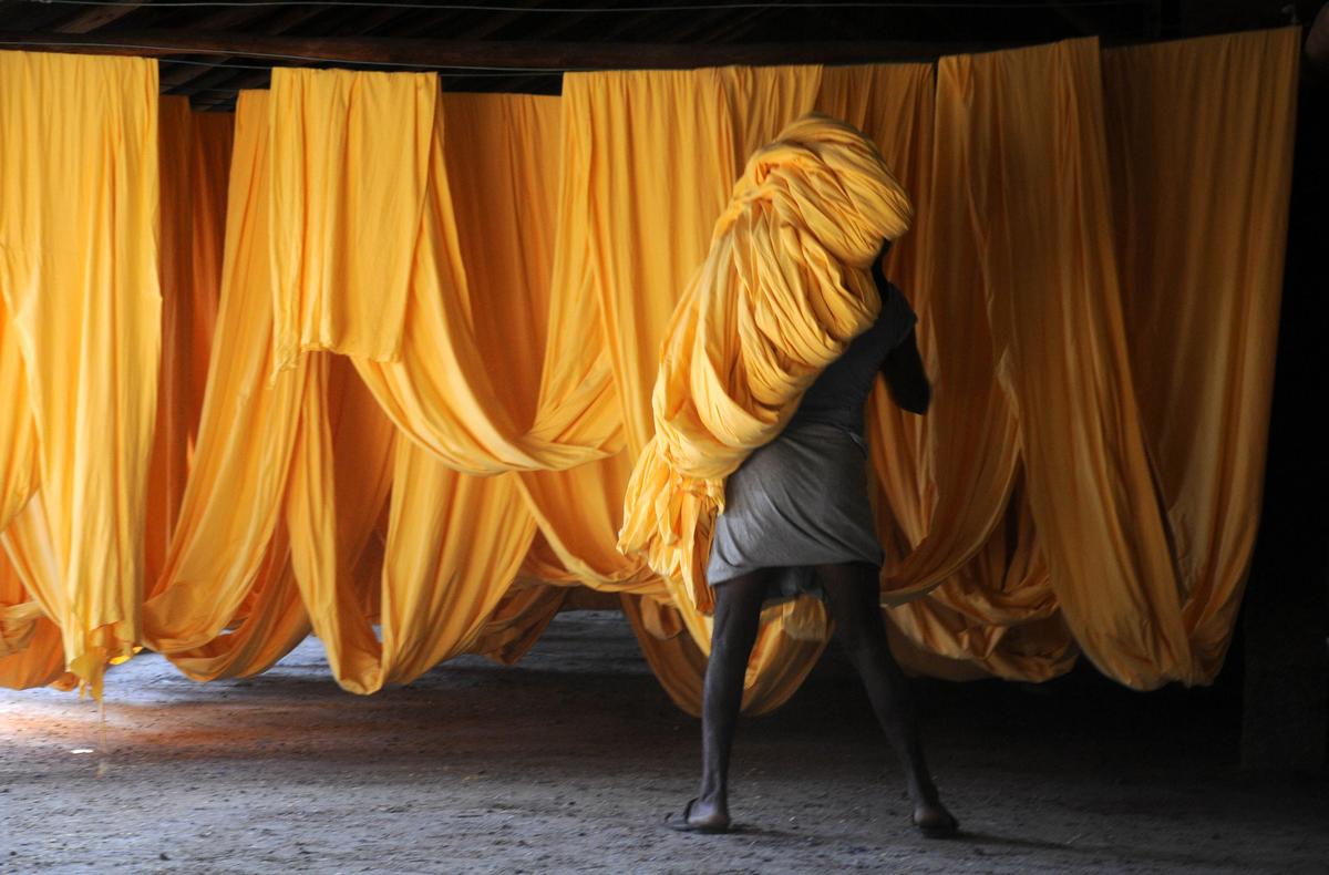 A worker drying clothes after the dyeing at a unit in Tirupur in Tamil Nadu. Photo: K. K. Mustafah