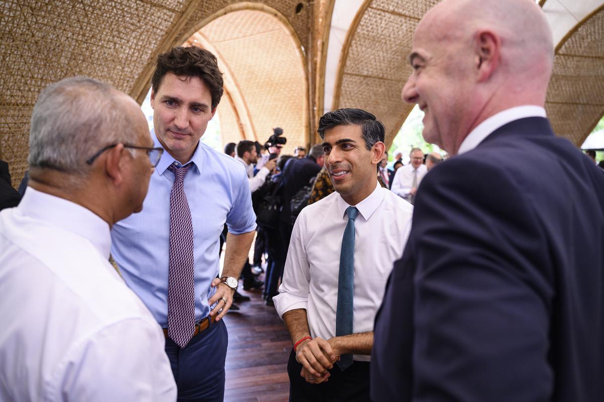 Canadian Prime Minister Justin Trudeau, Britain’s Prime Minister Rishi Sunak and FIFA President Gianni Infantino chat ahead of a working lunch at the G-20 Summit on November 15, 2022, in Nusa Dua, Bali, Indonesia.
