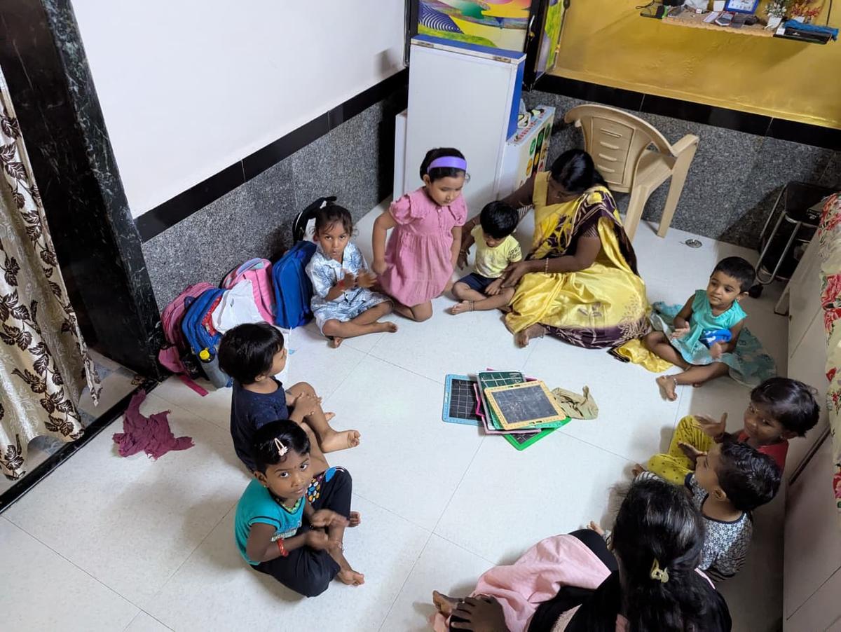 Meena Sunil Mohite, a teacher at an anganwadi centre in Dharavi, with children. Meena Sunil Mohite, a teacher at an anganwadi centre in Dharavi, with children.