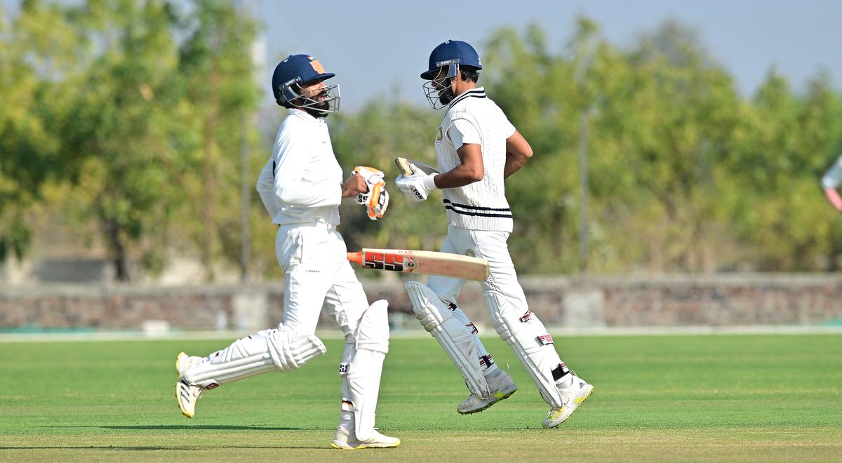 Saurashtra’s Harvik Desai and Ravindra Jadeja during the Ranji Trophy match against Delhi at the Niranjan Shah Stadium in Rajkot on Thursday, January 23, 2025.