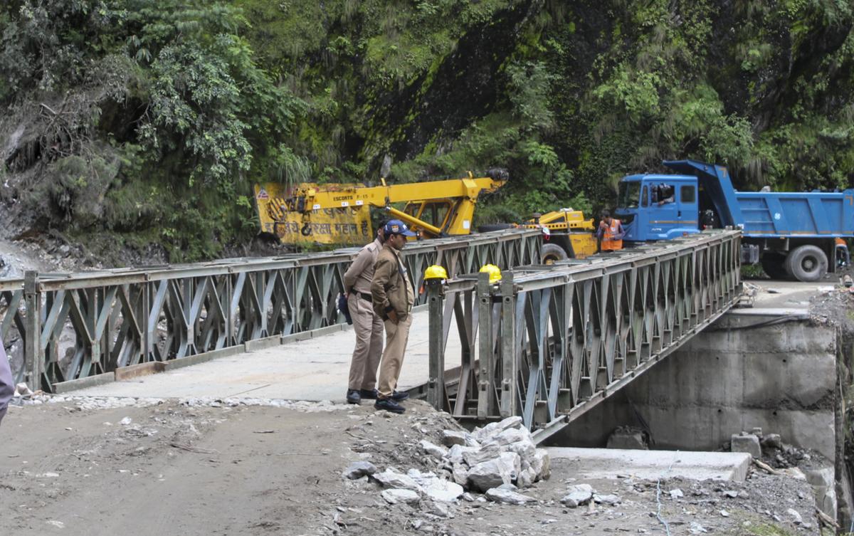 general Police personnel stand near a Bailey bridge along the Gangotri National Highway after its completion at a disaster-hit area in the aftermath of the recent flash floods, in Uttarkashi district, Uttarakhand on August 11, 2025. general Police personnel stand near a Bailey bridge along the Gangotri National Highway after its completion at a disaster-hit area in the aftermath of the recent flash floods, in Uttarkashi district, Uttarakhand on August 11, 2025.